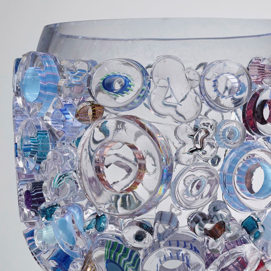 clear glass sculpted vessel with external circular glass adornments