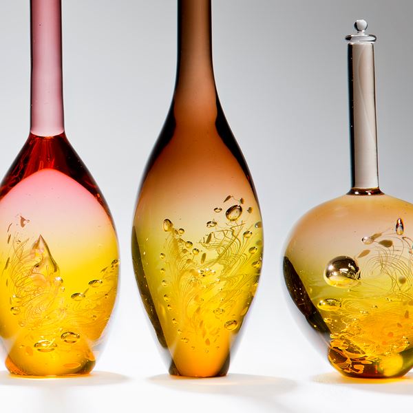 six assorted sculpted art glass bottles in amber and pastel