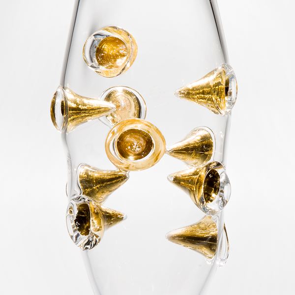 clear art glass vase with black base and embedded gold shards