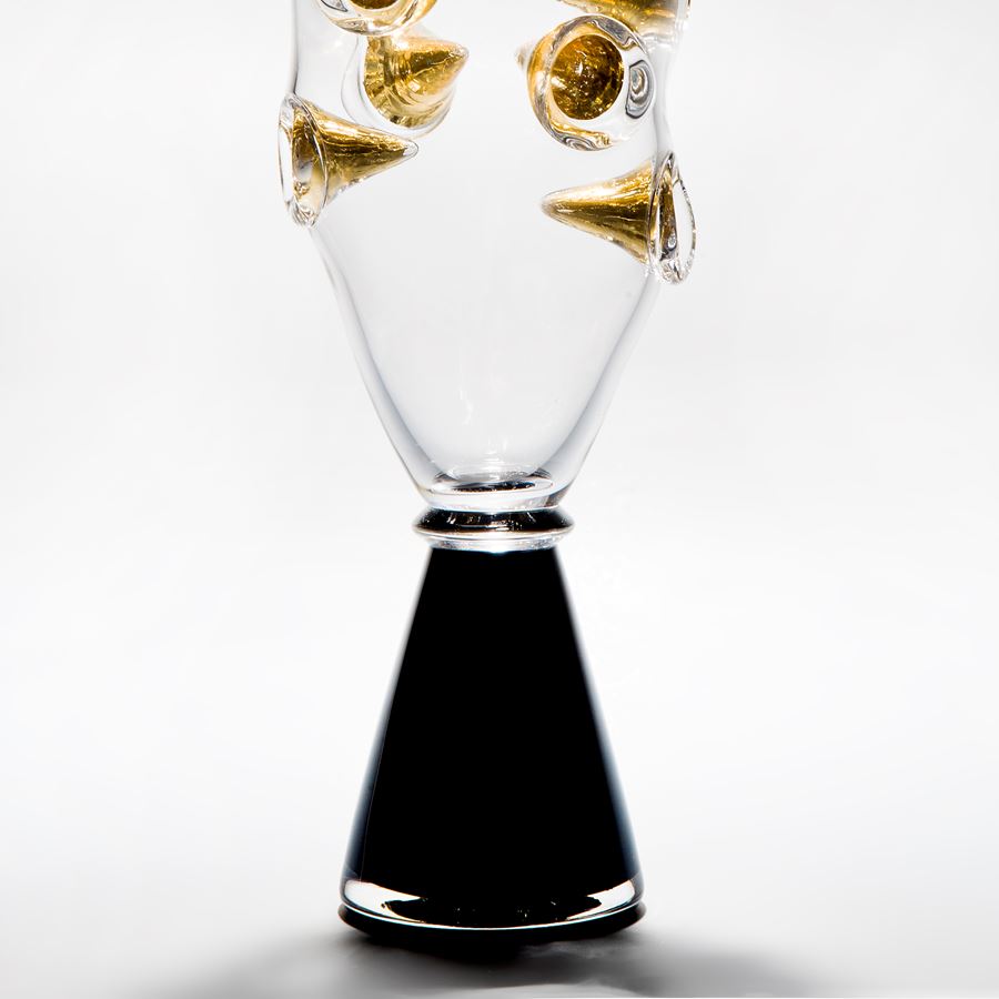 clear art glass vase with black base and embedded gold shards