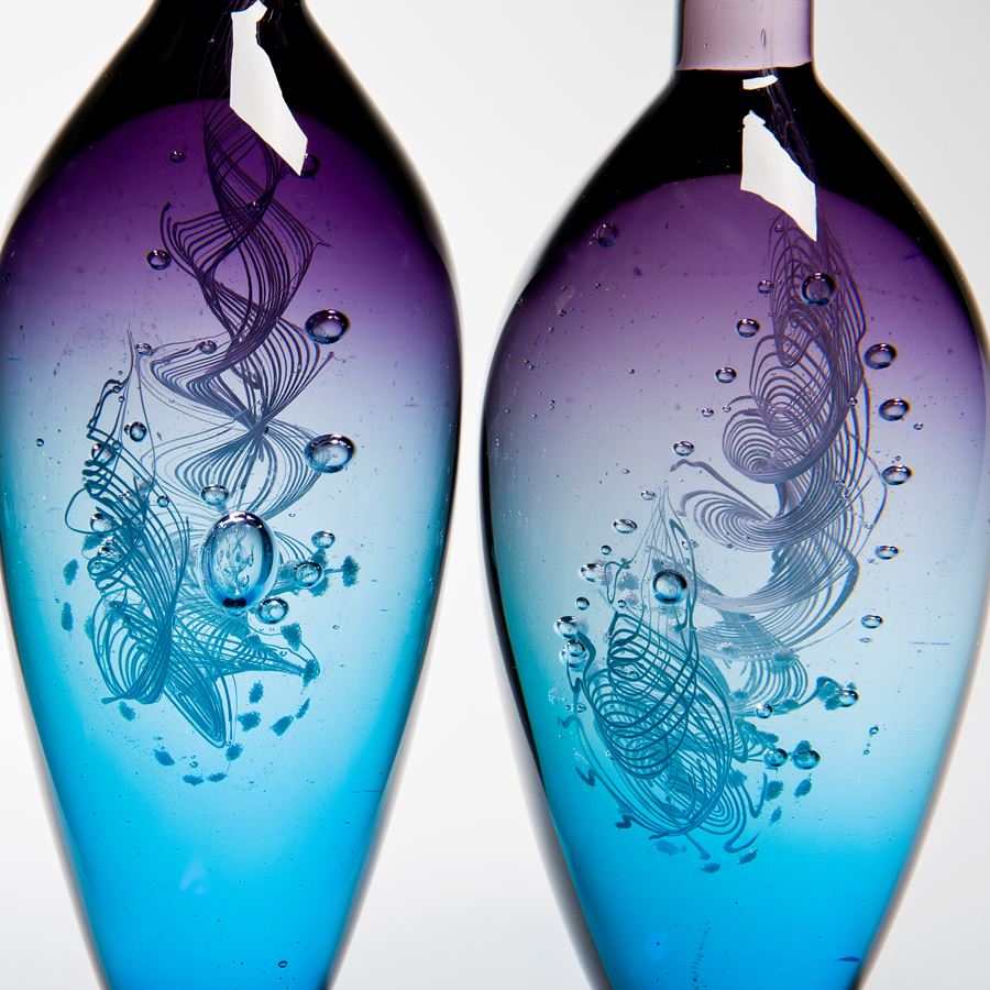 five handblown glass vase sculptures with long necks in pink purple and blue