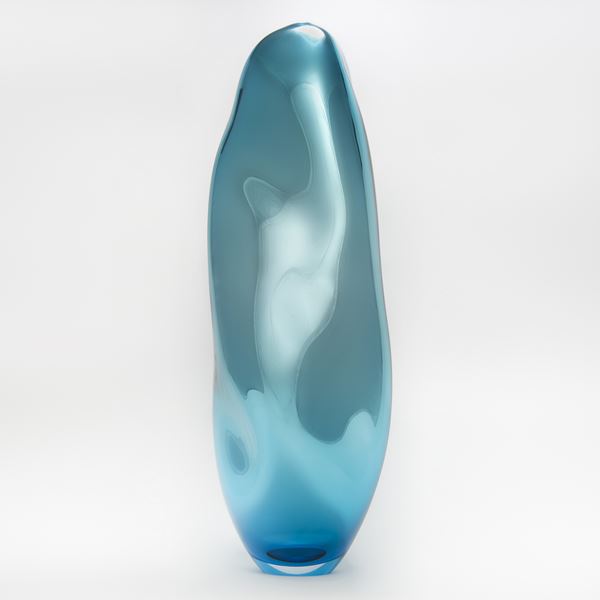 turquoise and light blue blown glass sculpture art in abstract tall vase shape