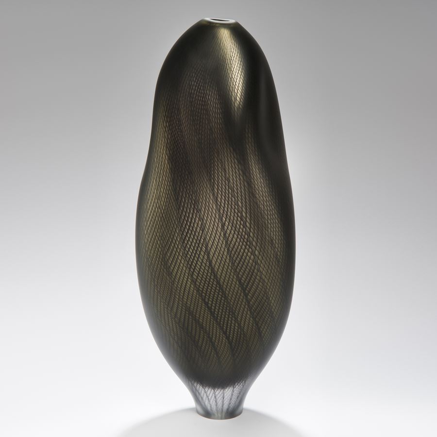 dark and light grey glass art sculpture of abstract vase shape with patterned exterior