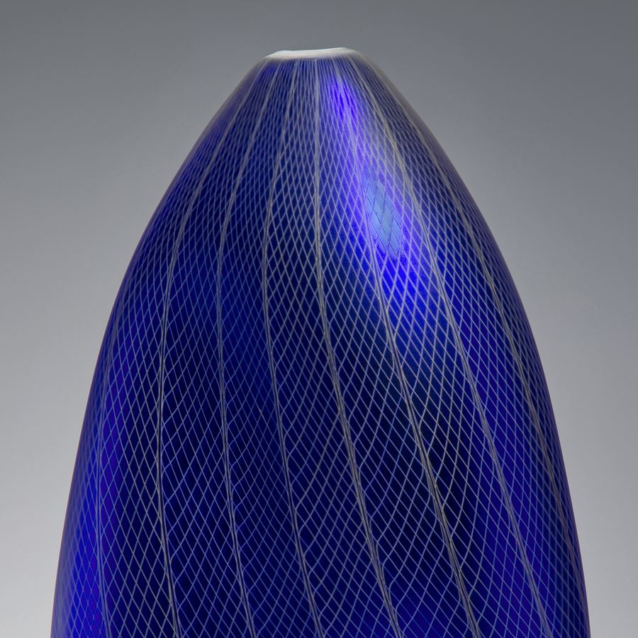 tall oval shaped dark blue vase sculpture with grey patterned exterior