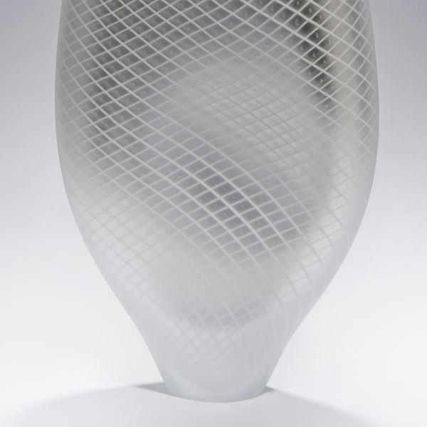 tall abstract blown glass vase in light grey with cross patterned exterior