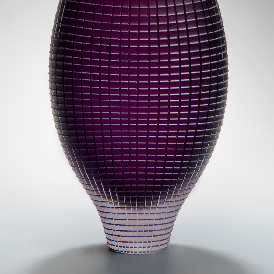tall and wide handblown glass vase in dark purple with chequered external pattern
