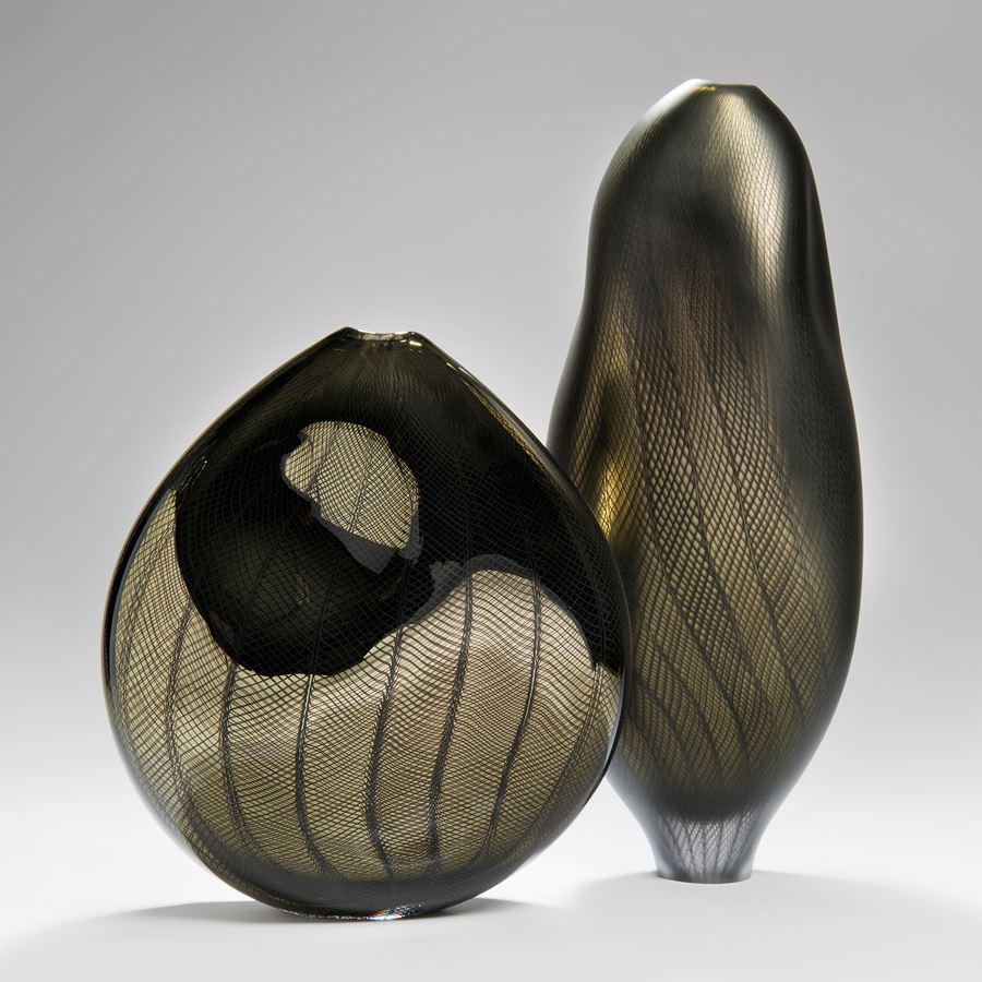 handblown minimalist glass teardrop shaped sculpted vessel in dark gold and black with wave checked external pattern