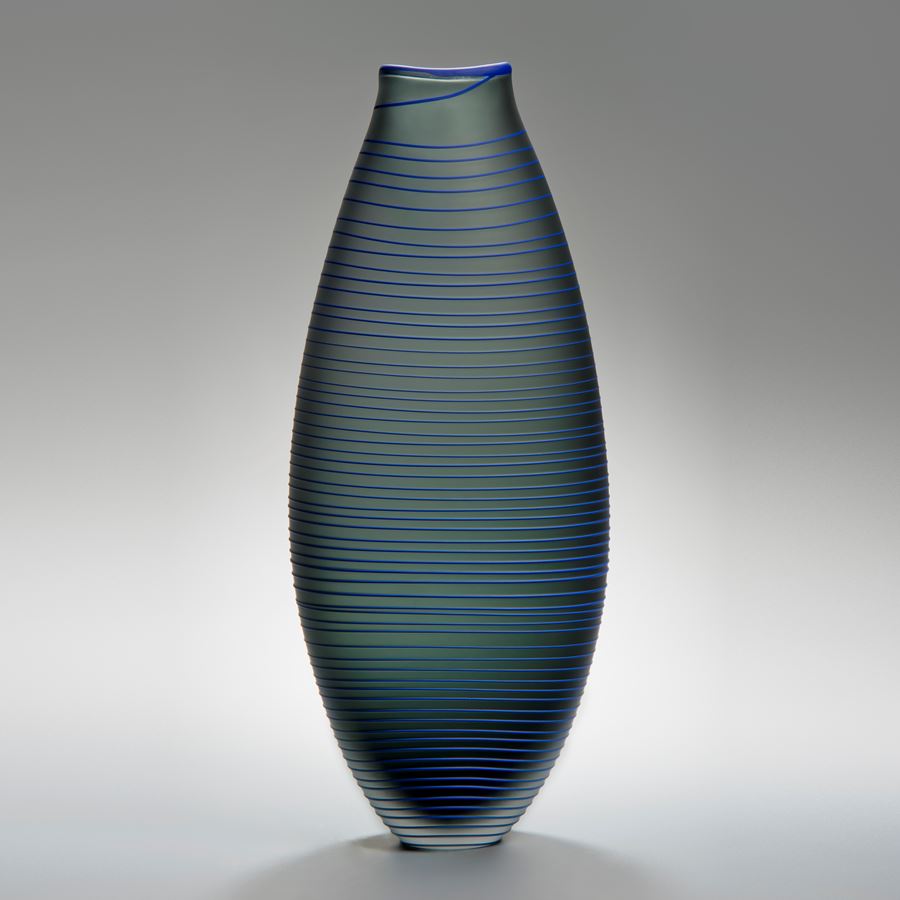 tall grey art glass vase with thin blue horizontal lines