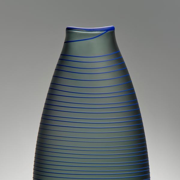 tall grey art glass vase with thin blue horizontal lines