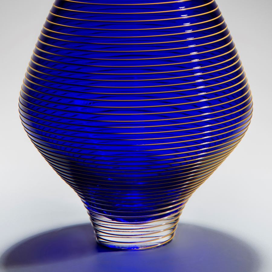 minimalist short electric blue glass  vase sculpture with faint yellow horizontal line pattern