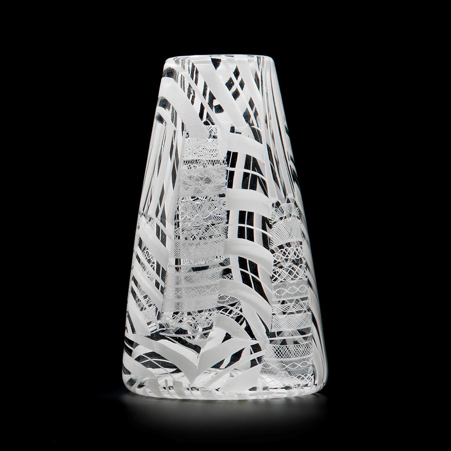 clear glass sculpted vessel with white patterned exterior