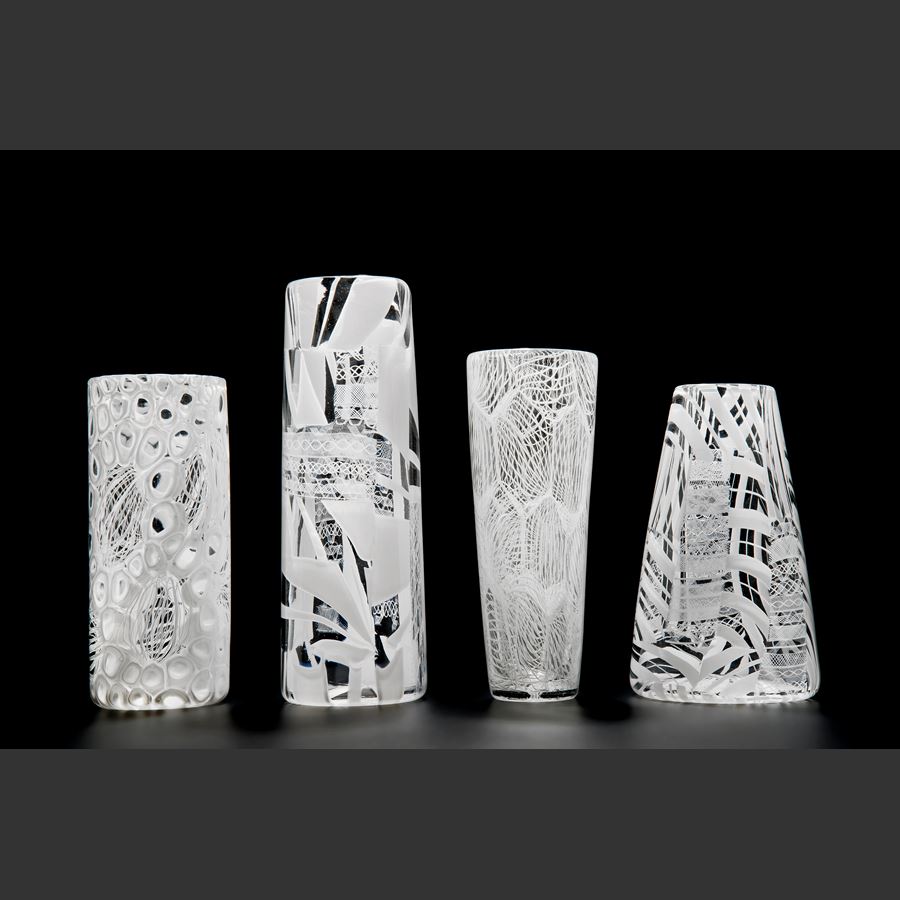 tall clear glass sculpture with external white pattern