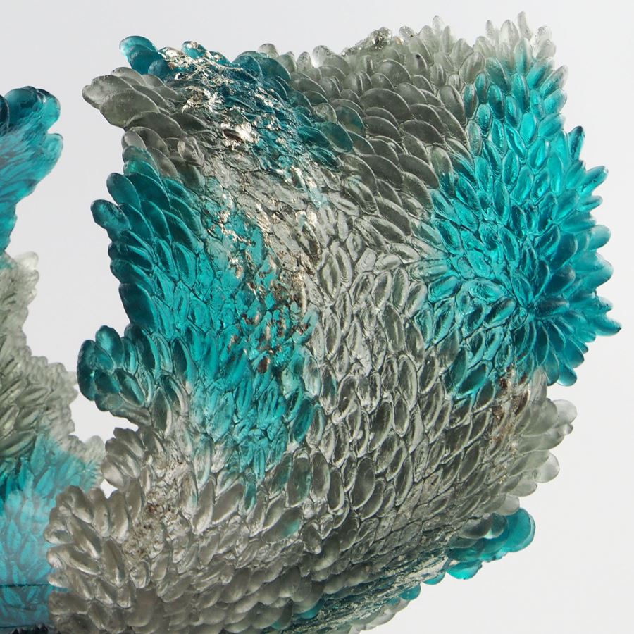 turquoise and clear art glass concave sculpture of wave shape