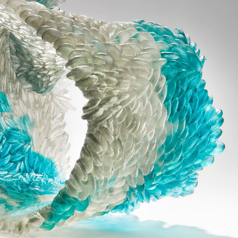 modern art glass sculpture of curled form in turquoise and clear glass
