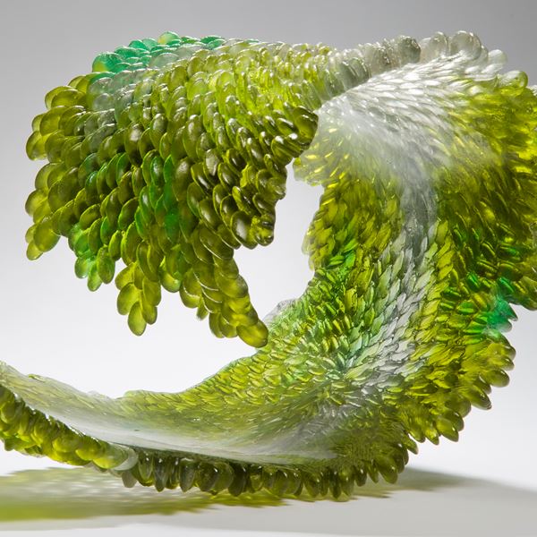 modern art glass sculpture of curled leaf in green