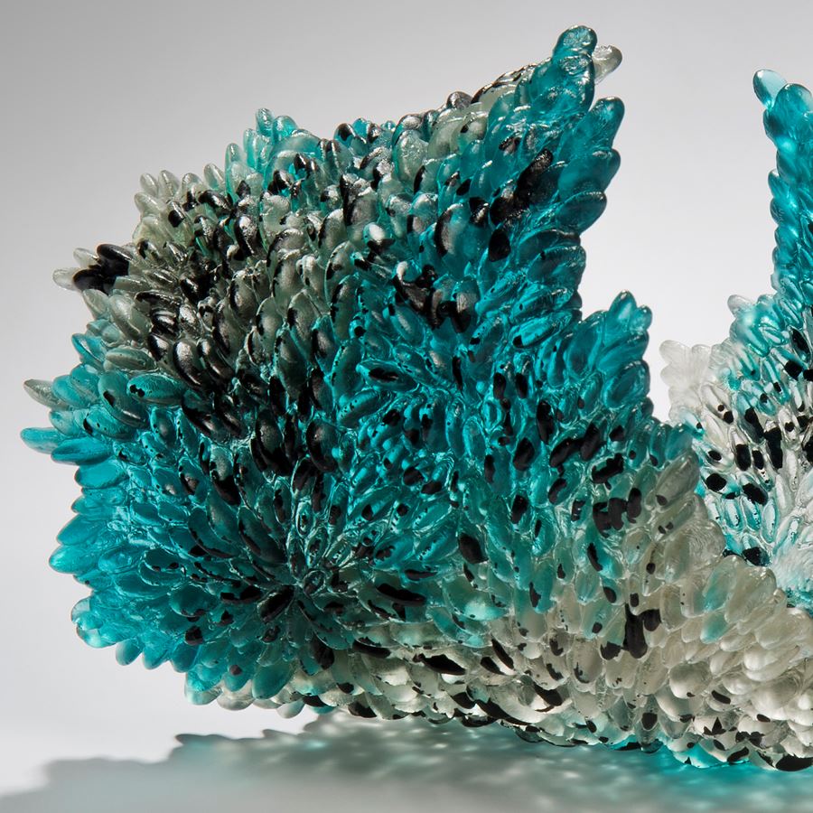art-glass sculpture of curled leaf in turquoise black and crystal