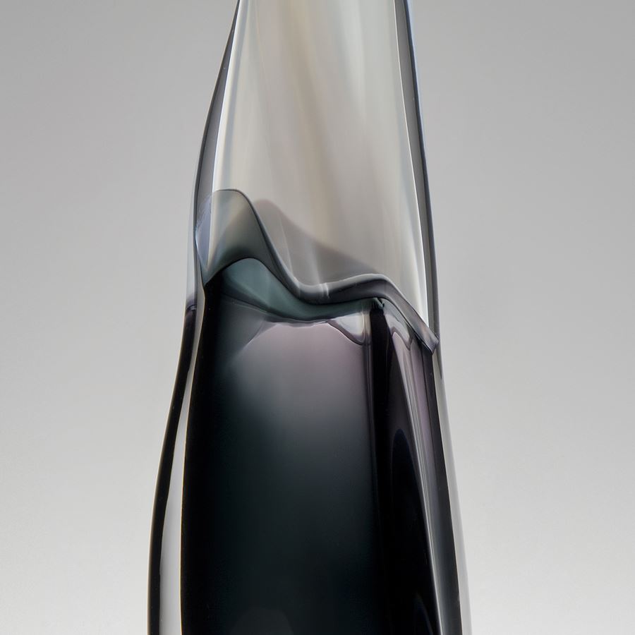 tall thin blown glass vase with black lower and clear upper halves