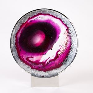 pink, purple and white round glass sculpture with eye like shape on bezel and stand