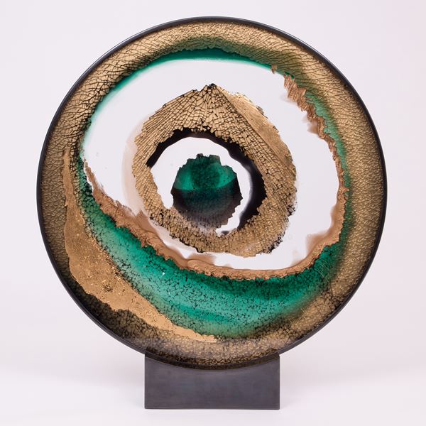 round art glass sculpture of eye like shape in white sand and green