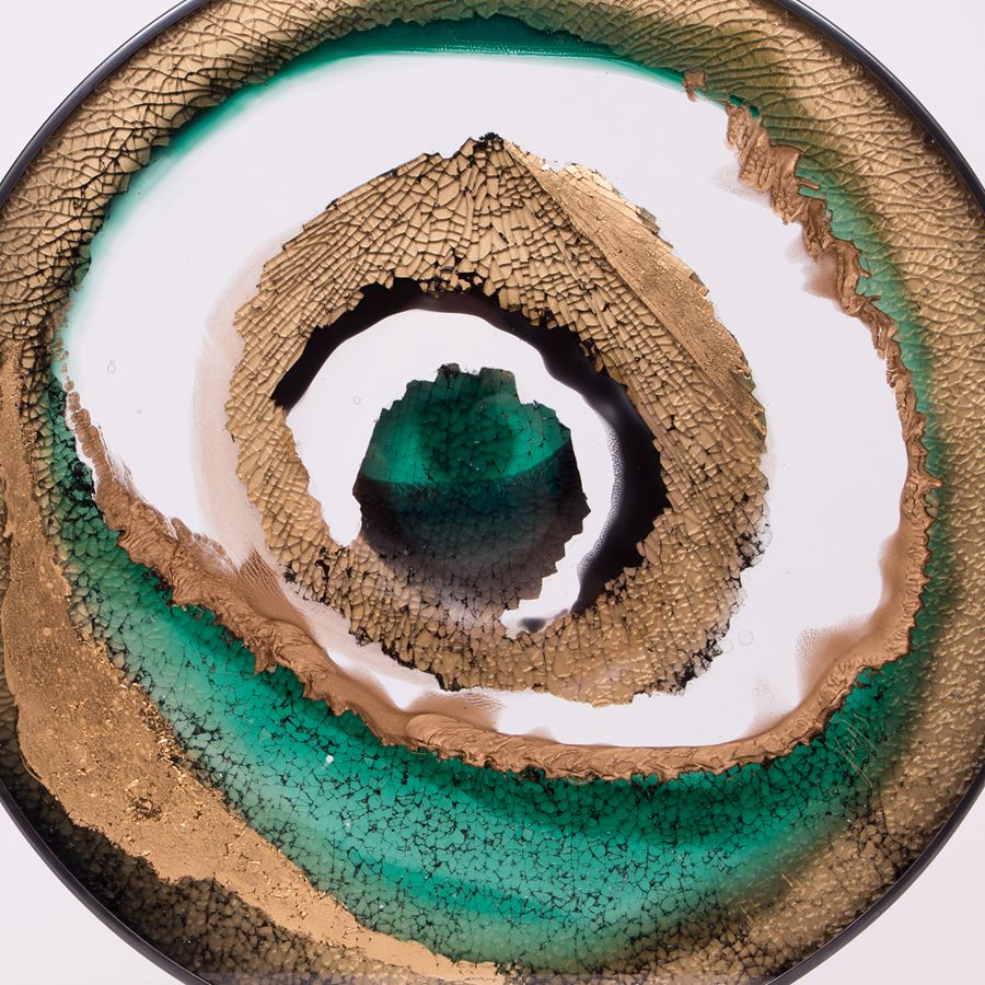 round art glass sculpture of eye like shape in white sand and green