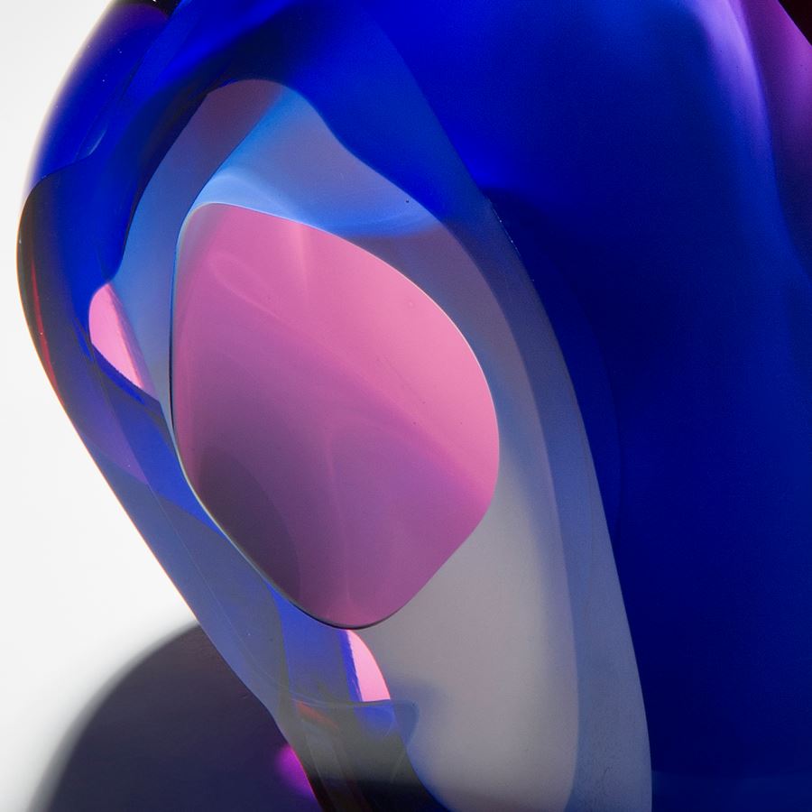 modern vug shaped abstract art glass sculpture in neon pink and dark blue