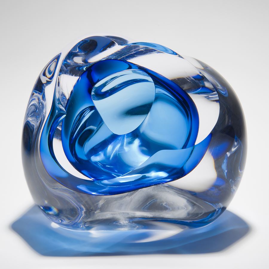 abstract modern glass sculpture of a vug in clear and light blue colours