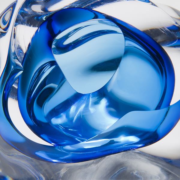 abstract modern glass sculpture of a vug in clear and light blue colours