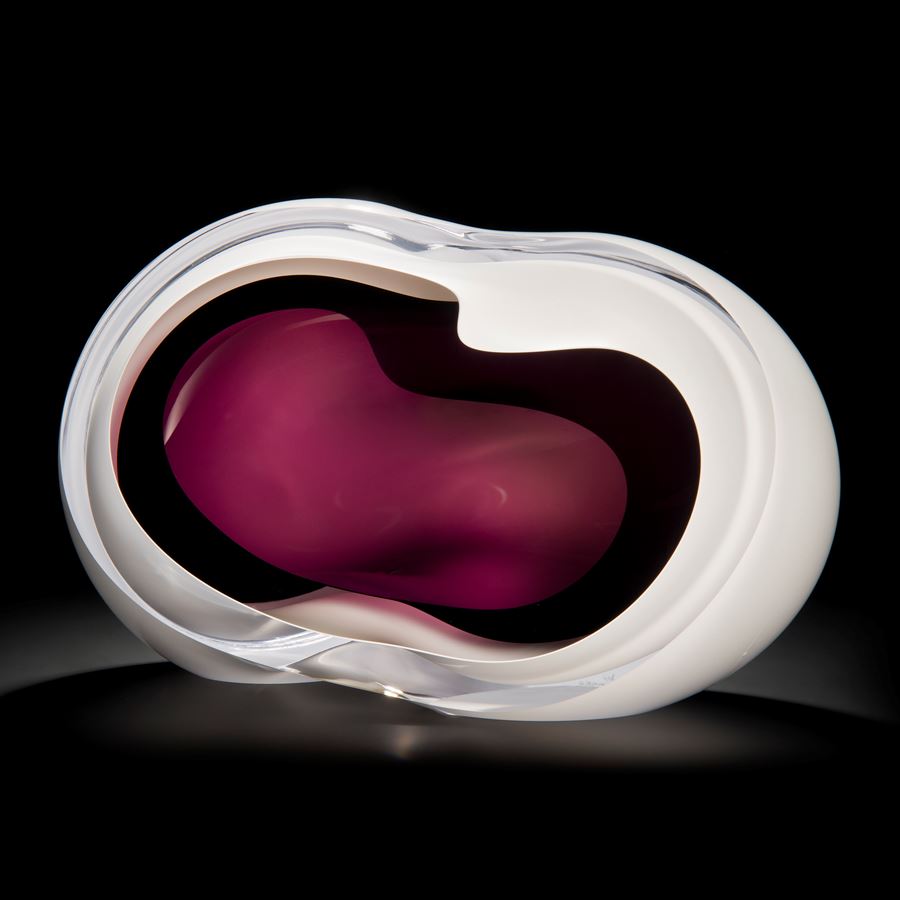 art glass sculpture of a vug in white with purple centre