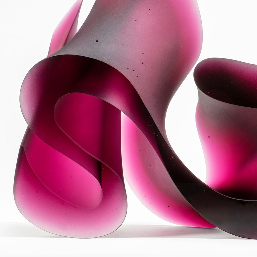 abstract geometric contemporary glass sculpture of squiggle in pink and black
