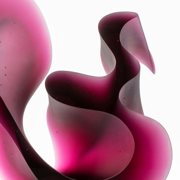 abstract geometric contemporary glass sculpture of squiggle in pink and black