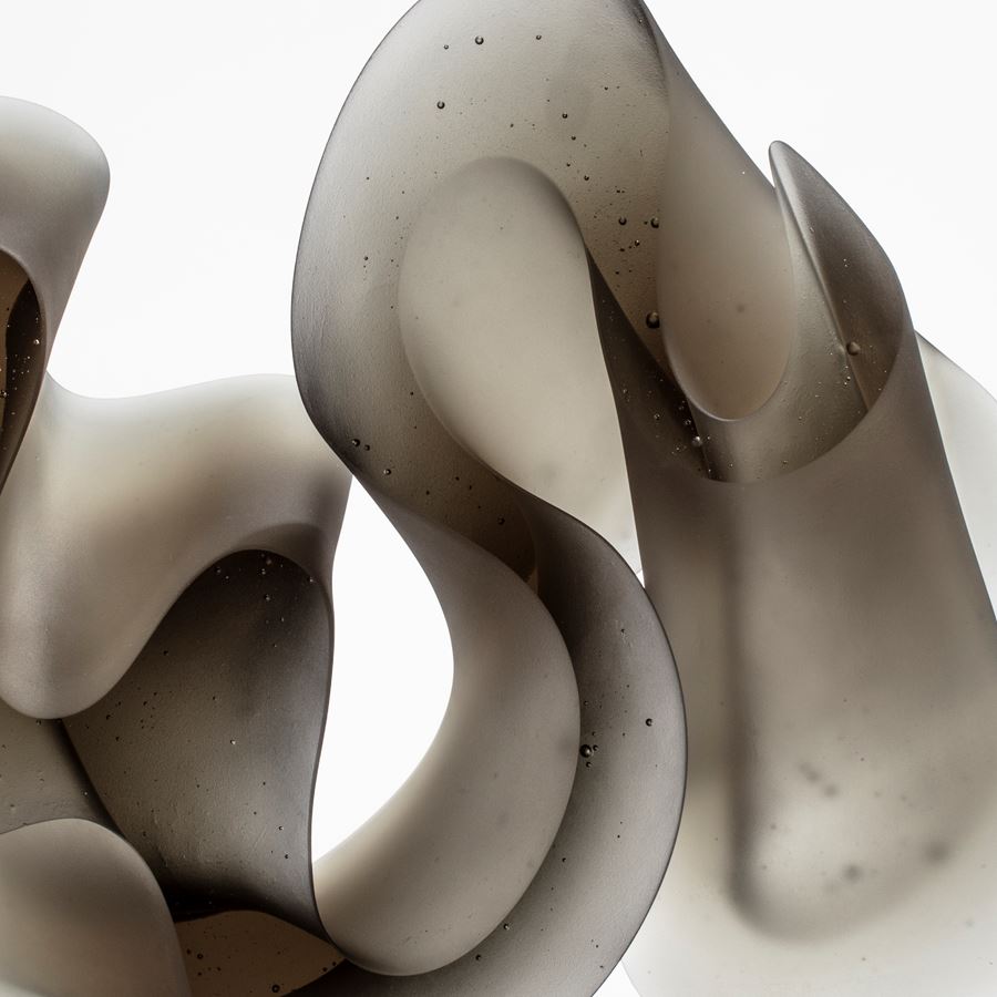 contemporary abstract art-glass scultpture of squiggly line in grey and white