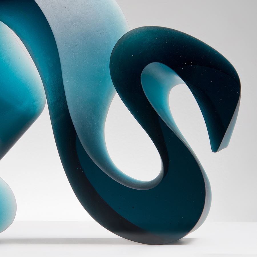 abstract contemporary glass art sculpture of a squiggly line in jade 