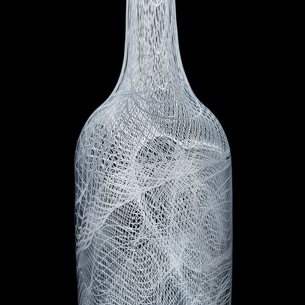 tall art glass bottle with intricate cane pattern