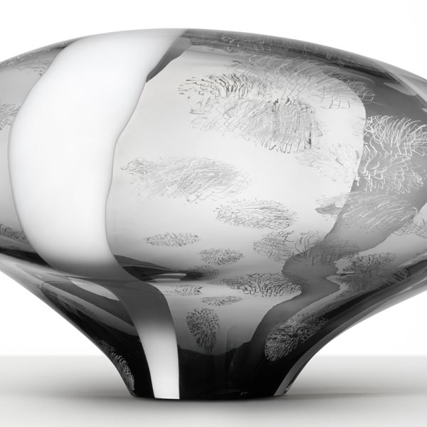 abstract brain-shaped clear glass sculpture in clear and grey with faint cloud like patterns throughout 