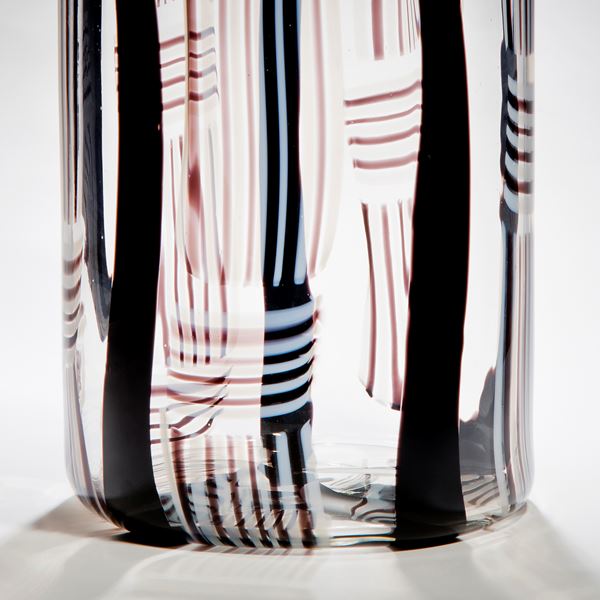 tall rounded and minimalist art glass sculpture in clear glass with black red and white line pattern