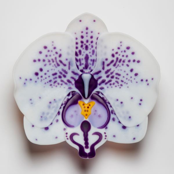 glass sculpture of white exotic flower with purple spots