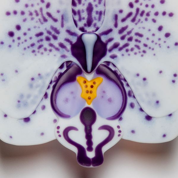 glass sculpture of white exotic flower with purple spots