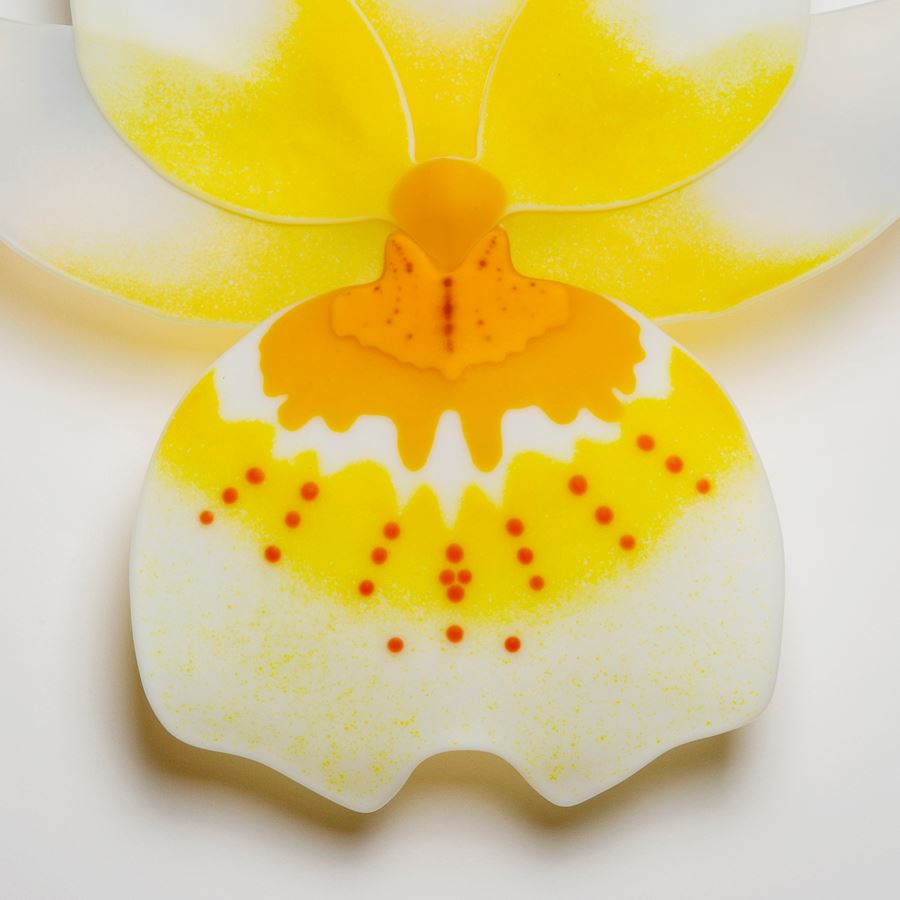 glass sculpture of pansy flower in yellow and white