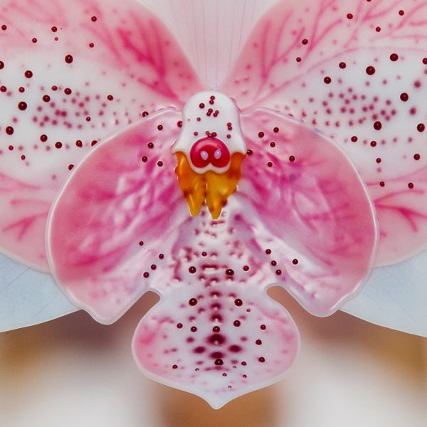 sculpted glass art of an exotic orchid in white and pink