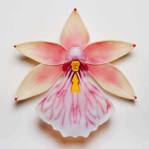 sculpted glass art of an exotic flower in white pink and yellow