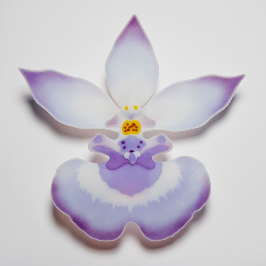 glass art sculpture of exotic flower in white and mauve