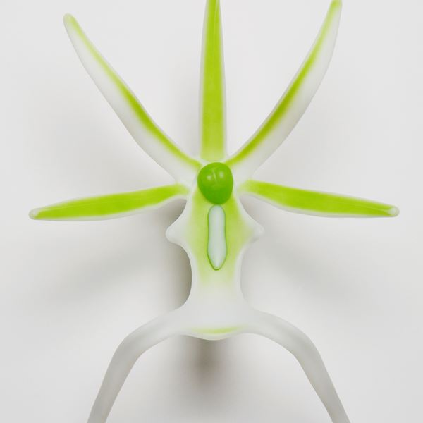 glass sculpture of ghost orchid in white and neon green