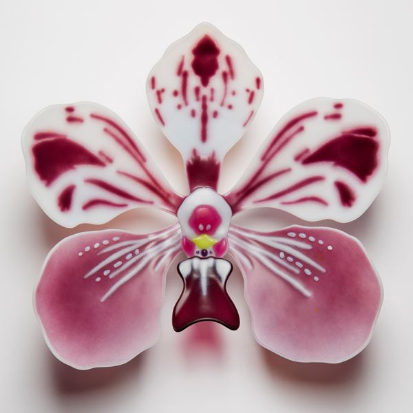 sculpted glass art of an exotic flower in pink and white