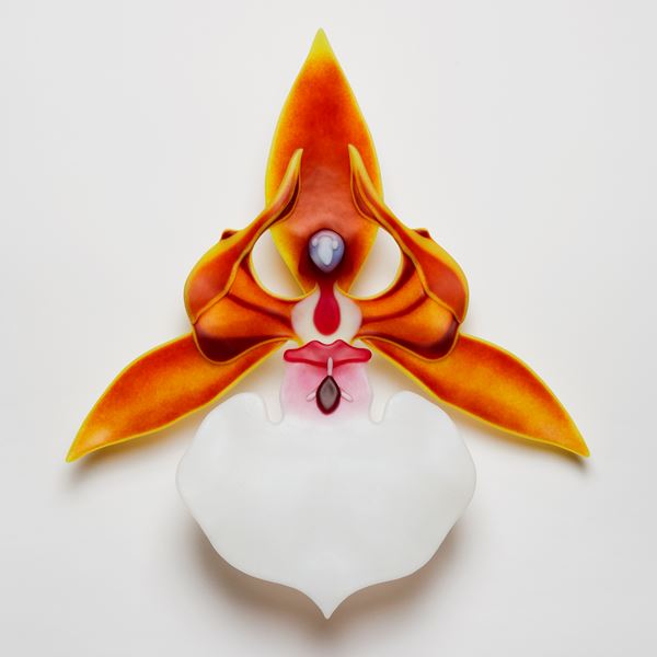 glass art sculpture of an exotic flower in white and orange