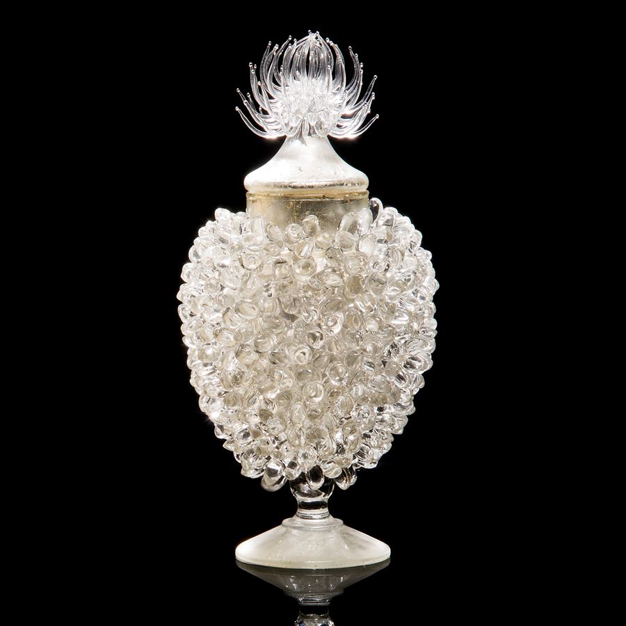 whiite glass sculpture of prickly centred jar with steel gilding 
