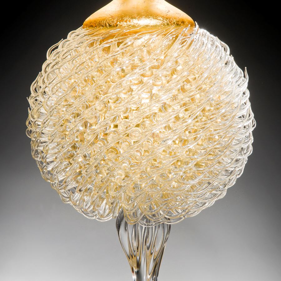 tall art glass jar sculpture with long base and gold thistle body