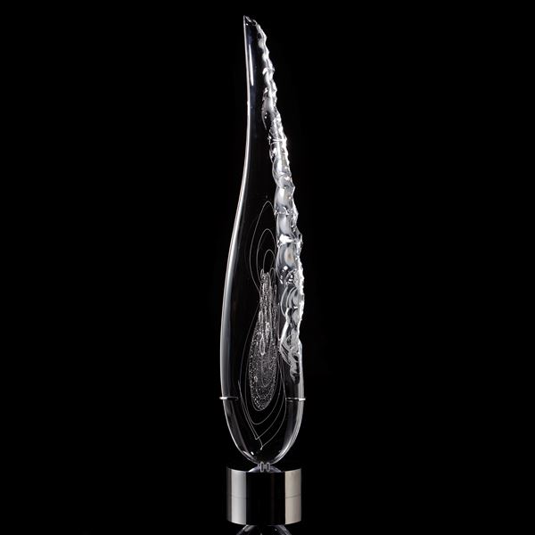 tall thin black art glass sculpture in the shape of a feather with hand chipped exterior patterns