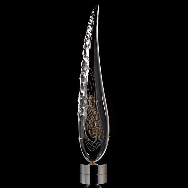 tall thin black art glass sculpture in the shape of a feather with hand chipped exterior gold patterns
