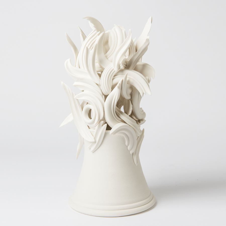 white ceramic sculpture of decorative architrave on potted base