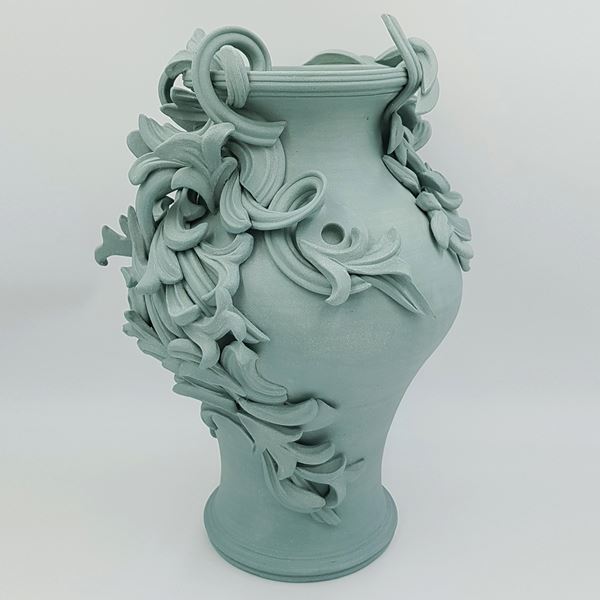 turquoise coloured decorative stoneware vase sculpture with ornate flower trim